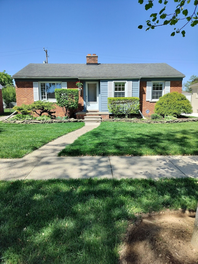 9909 Brookfield St, Livonia, MI 48150 - ranch-style home with brick siding, a chimney, and a front lawn