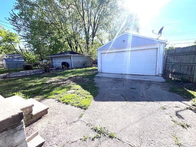detached garage featuring fence
