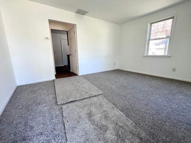 carpeted spare room with baseboards