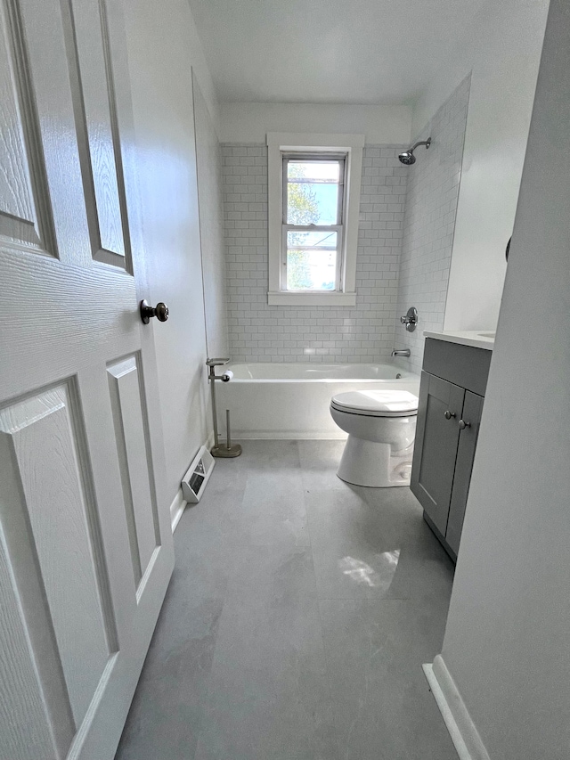 full bath featuring toilet, washtub / shower combination, vanity, and baseboards