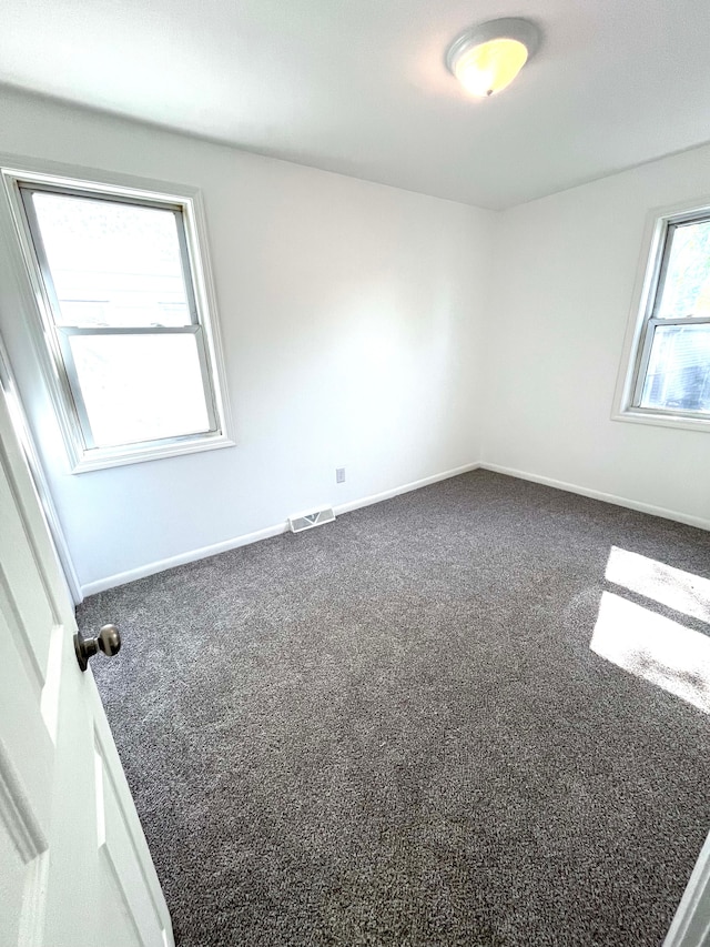 empty room with carpet flooring and baseboards