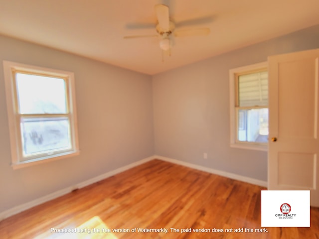empty room featuring light wood-type flooring, baseboards, and ceiling fan