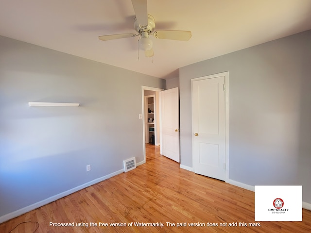 unfurnished bedroom featuring baseboards, wood finished floors, and a ceiling fan