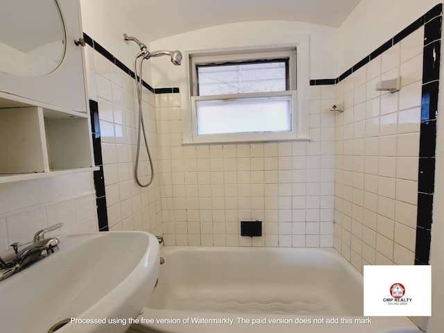 bathroom with a sink and bathtub / shower combination