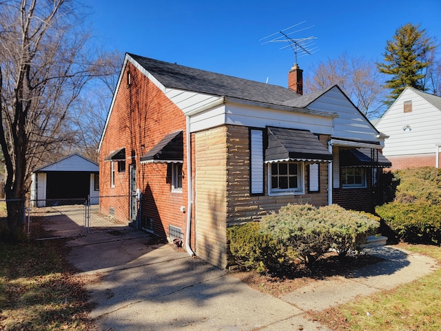 view of front of property featuring a gate, a chimney, fence, and brick siding