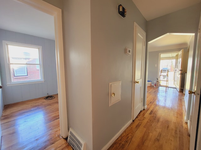 corridor featuring light wood-style floors and baseboards