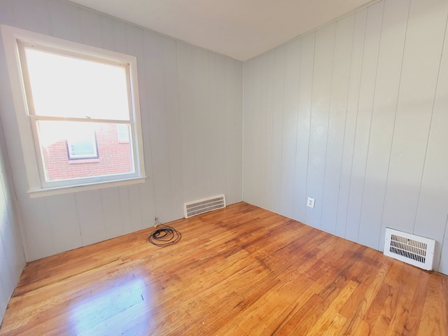 spare room with wood finished floors