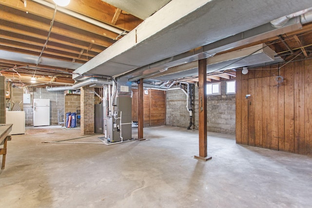225 Van Buren St, South Haven, MI 49090 - below grade area featuring freestanding refrigerator, heating unit, and washing machine and dryer