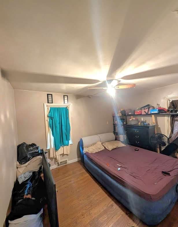 11301 Coyle St, Detroit, MI 48227 - bedroom with wood finished floors, ceiling fan, and baseboards