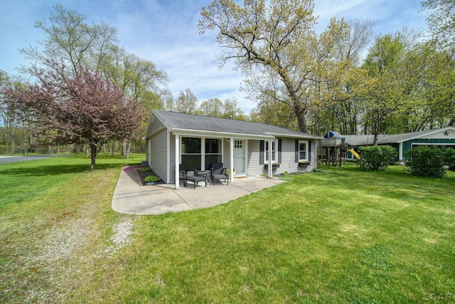 5541 Pleasant Valley Rd, Manitou Beach, MI 49253 - rear view of property with a lawn, a playground, and a patio area