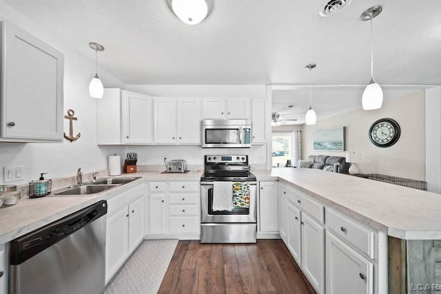 5541 Pleasant Valley Rd, Manitou Beach, MI 49253 - kitchen with appliances with stainless steel finishes, a peninsula, light countertops, a ceiling fan, and white cabinets
