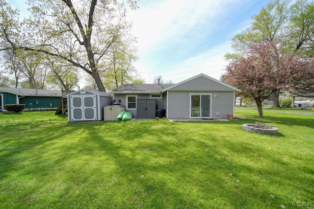 5541 Pleasant Valley Rd, Manitou Beach, MI 49253 - back of house with a storage shed, a lawn, and a fire pit