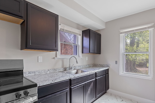 15470 Murray Hill St, Detroit, MI 48227 - kitchen with stainless steel range with electric stovetop, a sink, light marble finish floors, and healthy amount of natural light