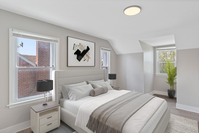 15470 Murray Hill St, Detroit, MI 48227 - bedroom featuring multiple windows, wood finished floors, baseboards, and vaulted ceiling