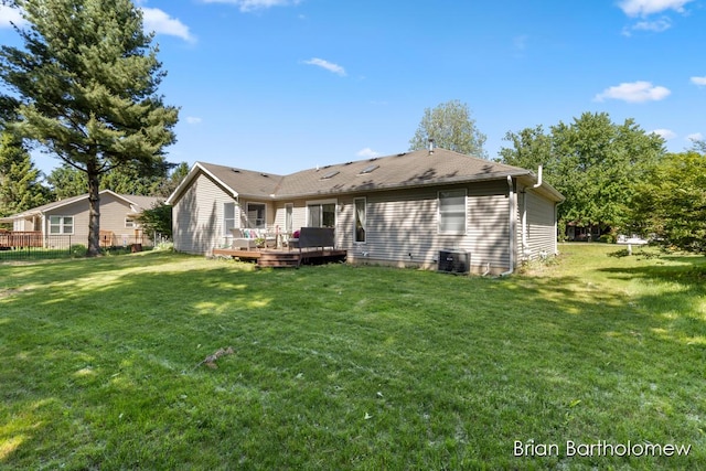 2657 Leffingwell Ave NE, Grand Rapids, MI 49525 - rear view of house featuring a wooden deck, a lawn, and cooling unit
