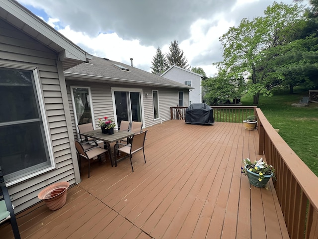 2657 Leffingwell Ave NE, Grand Rapids, MI 49525 - wooden deck with outdoor dining space, a yard, and area for grilling