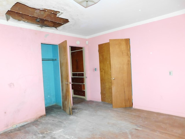 unfurnished bedroom featuring unfinished concrete floors and a closet