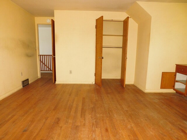 unfurnished bedroom with wood finished floors and baseboards