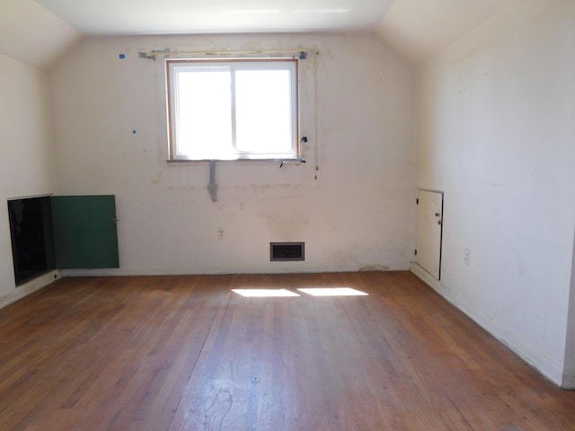 bonus room featuring vaulted ceiling and hardwood / wood-style flooring