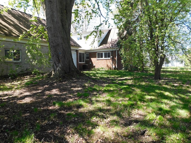 view of green lawn featuring a garage