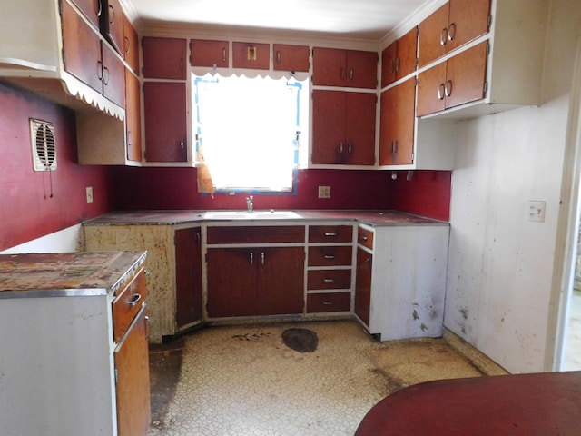 kitchen featuring a sink and brown cabinets