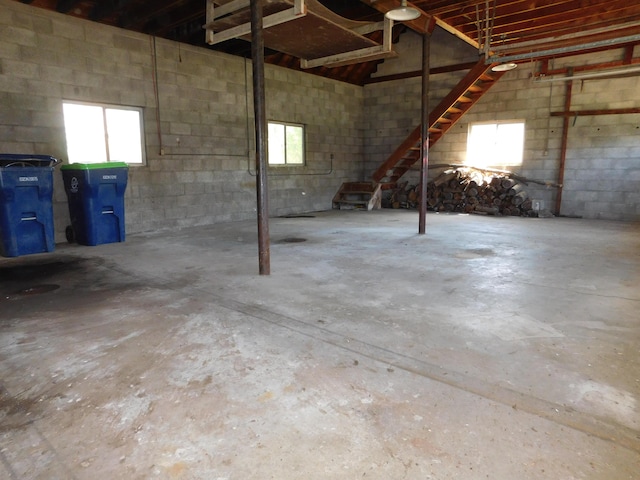below grade area with concrete block wall and plenty of natural light