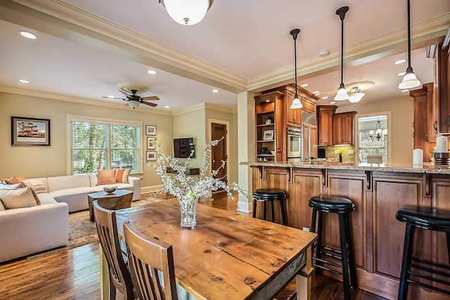 dining area featuring ornamental molding, ceiling fan, dark wood-style flooring, recessed lighting, and baseboards