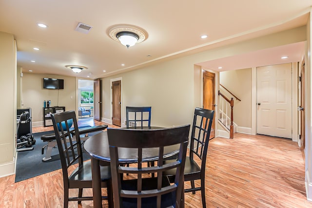 dining room with stairway, light wood-type flooring, recessed lighting, and baseboards