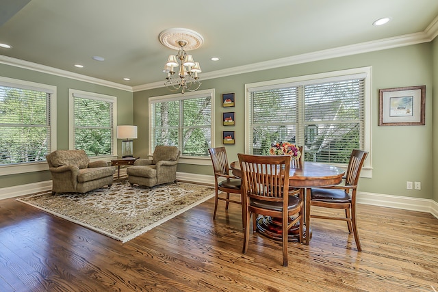 dining room featuring baseboards, a chandelier, crown molding, wood finished floors, and recessed lighting