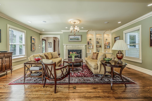 living room with arched walkways, baseboards, wood finished floors, crown molding, and recessed lighting