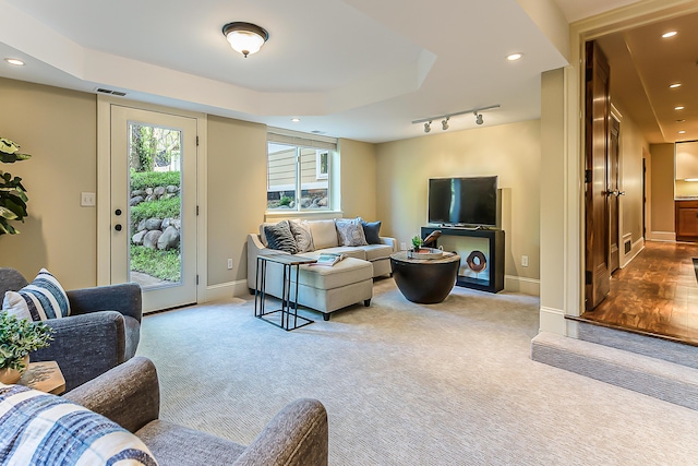 carpeted living room with recessed lighting and baseboards