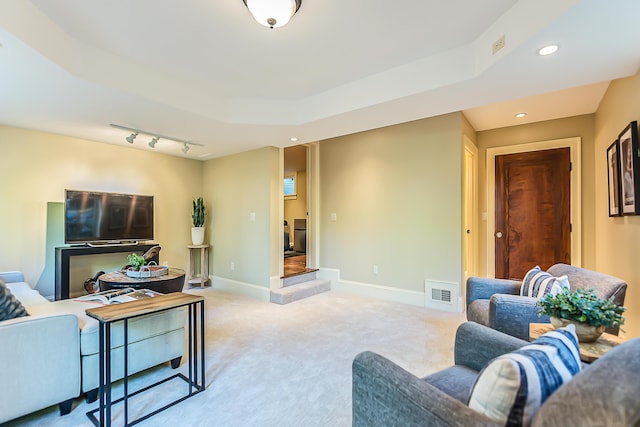 living room featuring light carpet, recessed lighting, baseboards, and track lighting
