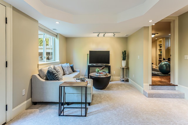carpeted living area featuring recessed lighting and baseboards
