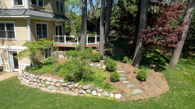 view of grassy yard with a deck