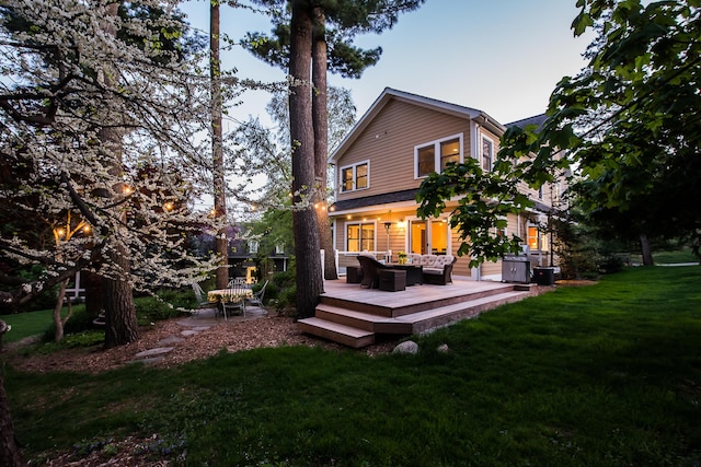 rear view of house featuring an outdoor living space, a lawn, a wooden deck, and central AC unit