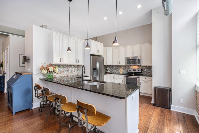 2214 S State St Unit 108, Saint Joseph, MI 49085 - kitchen featuring stainless steel appliances, a sink, wood finished floors, a peninsula, and recessed lighting
