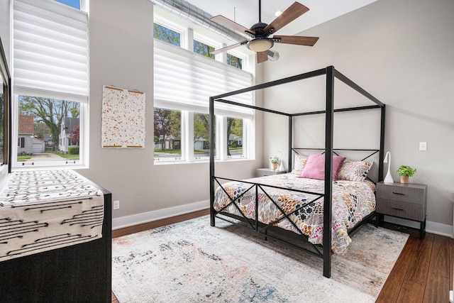 2214 S State St Unit 108, Saint Joseph, MI 49085 - bedroom featuring baseboards, multiple windows, wood finished floors, and a towering ceiling