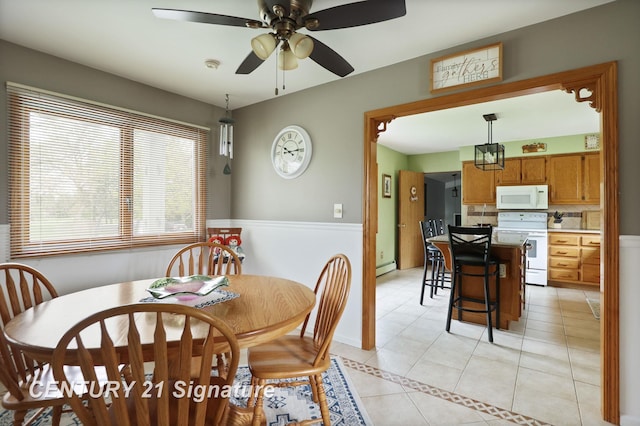 919 E Salzburg Rd, Bay City, MI 48706 - dining area featuring light tile patterned flooring, a ceiling fan, and baseboard heating