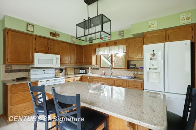 919 E Salzburg Rd, Bay City, MI 48706 - kitchen featuring white appliances, a sink, tasteful backsplash, brown cabinetry, and a center island