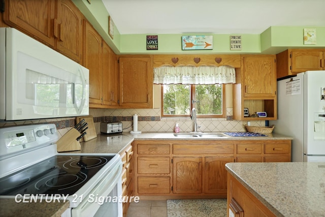 919 E Salzburg Rd, Bay City, MI 48706 - kitchen with white appliances, a sink, decorative backsplash, light tile patterned floors, and brown cabinets