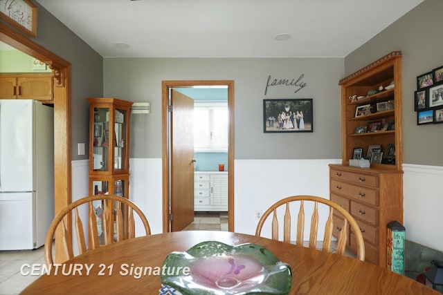 919 E Salzburg Rd, Bay City, MI 48706 - dining area with light tile patterned floors and wainscoting