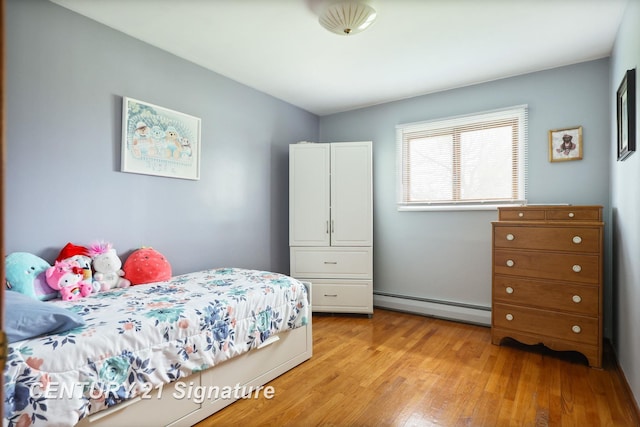 919 E Salzburg Rd, Bay City, MI 48706 - bedroom featuring baseboard heating and light wood-style flooring