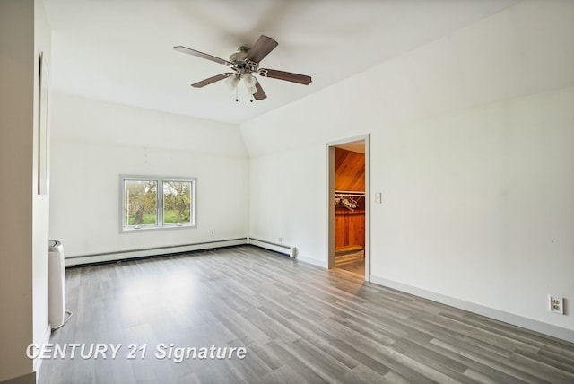 919 E Salzburg Rd, Bay City, MI 48706 - unfurnished room featuring a baseboard heating unit, a ceiling fan, wood finished floors, lofted ceiling, and baseboards