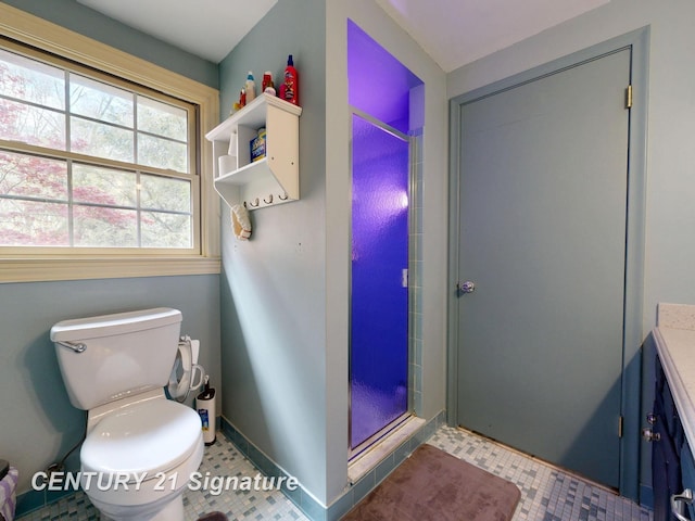 full bathroom featuring a stall shower, toilet, baseboards, and tile patterned flooring