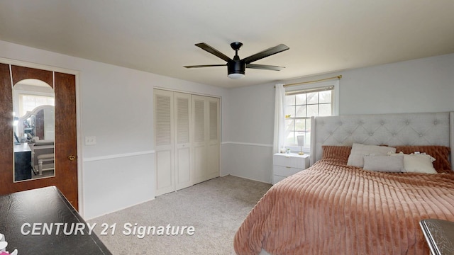 carpeted bedroom featuring a closet, ceiling fan, and arched walkways