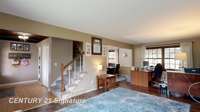 office space with wood finished floors, baseboards, and a chandelier