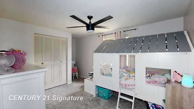 bedroom featuring light colored carpet, a closet, and a ceiling fan