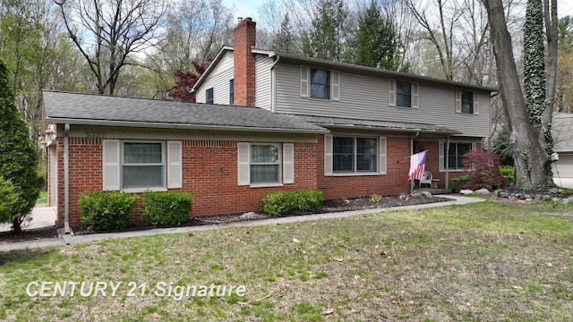 traditional home featuring brick siding, a front lawn, and roof with shingles