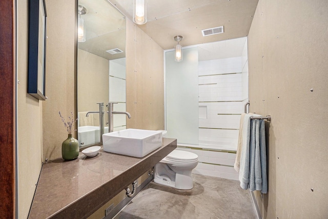 6723 Vandermeulen Rd, Holland, MI 49423 - bathroom featuring a sink, toilet, enclosed tub / shower combo, and concrete floors