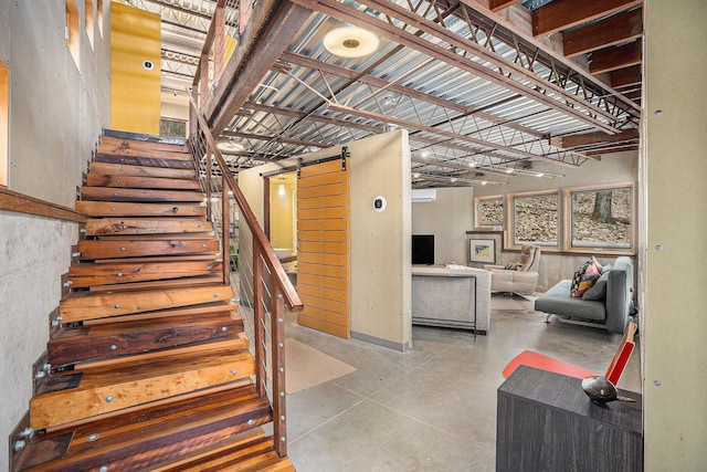 6723 Vandermeulen Rd, Holland, MI 49423 - staircase with a barn door and concrete flooring